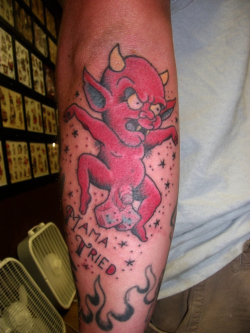 Red Ink Baby Devil Tattoo On Forearm