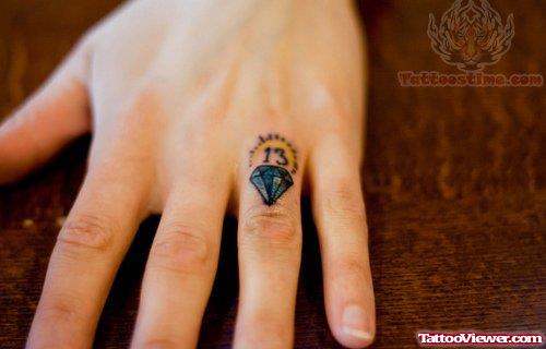 Tiny Blue Diamond Ring Tattoo