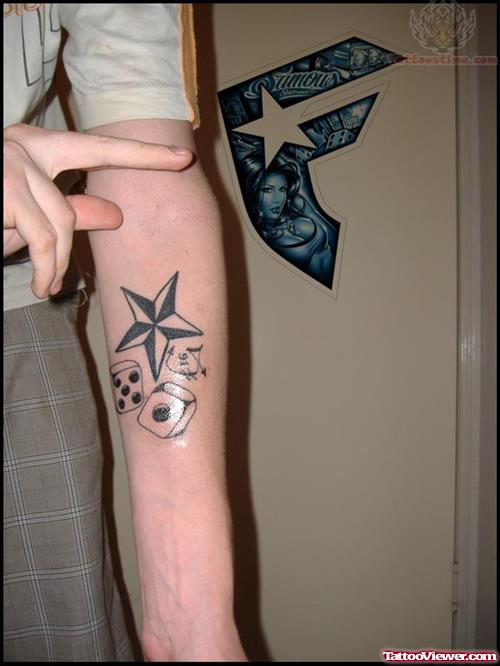 Nautical Star And Dice Tattoo On Arm