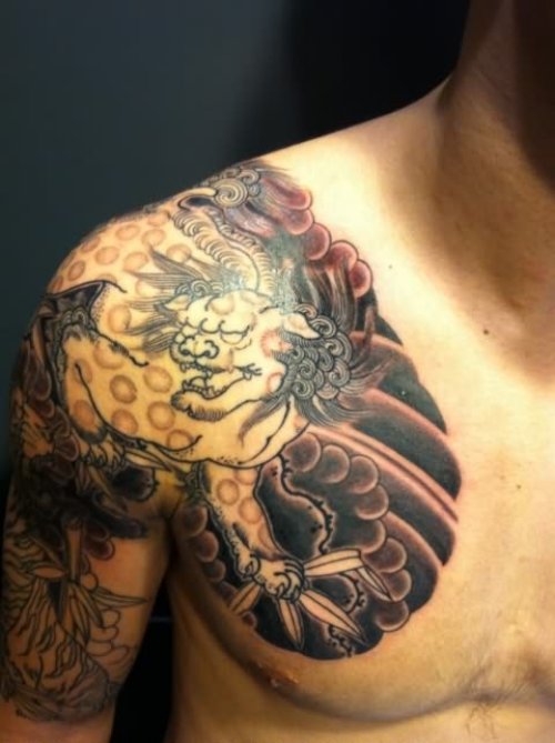 Fu Dog Tattoo On Chest And Shoulder