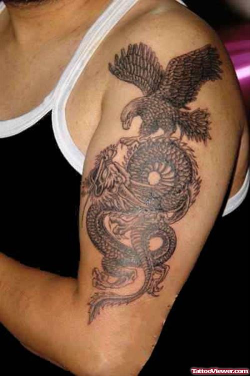 Grey Ink Dragon And Eagle Tattoo On Left Half Sleeve