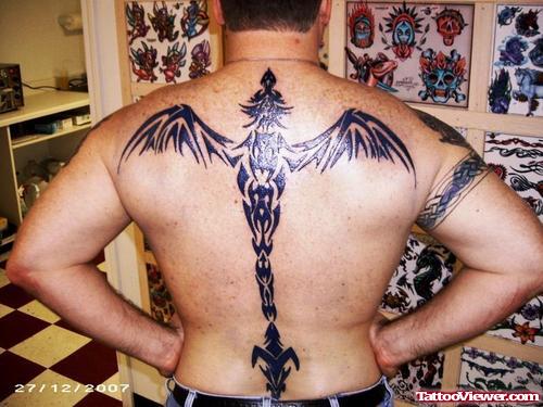 Black Ink Tribal Dragon Tattoo On Man Back