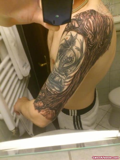 Grey ink Tree And Dragon Tattoo On Bicep