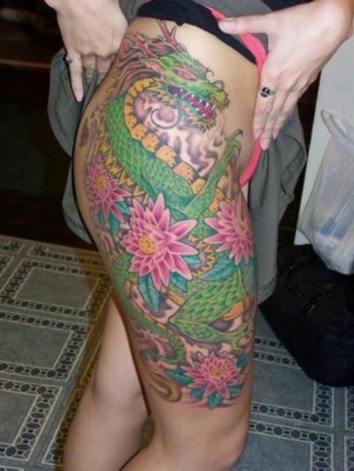 Colored Flowers and Green Dragon Tattoo On Girl Right Thigh