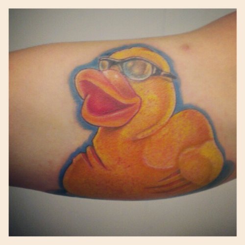 Duck With Spects Color Ink Tattoo On Bicep