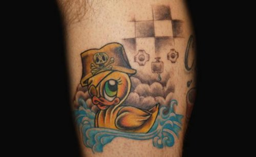 Yellow Ink Duck With Pirate Cap Tattoo On Bicep