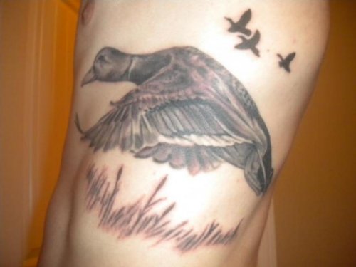 Left Side Grey Ink Flying Duck Tattoo For Men