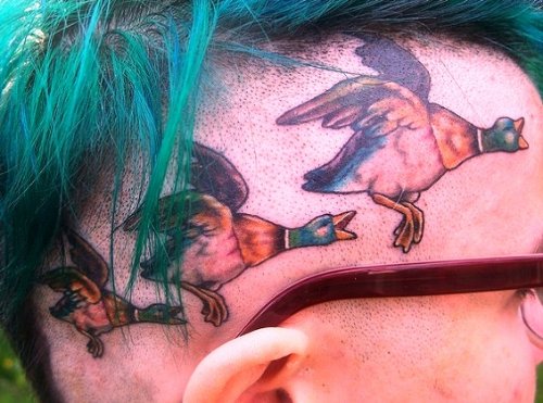 Colored Flying Ducks Tattoo On Head