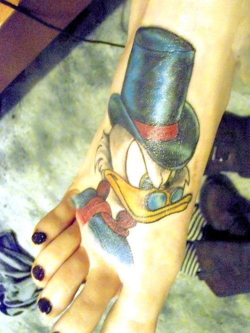 Color Donald Duck With Hat Tattoo On Right Foot
