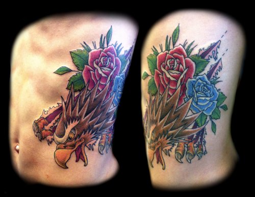 Red And Blue Rose Flowers And Eagle Tattoo On Side Rib