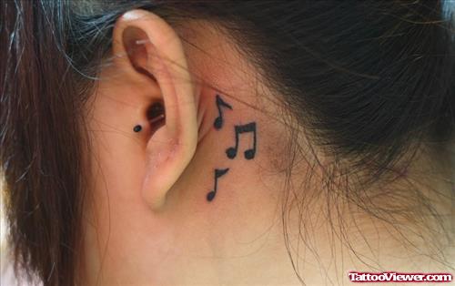 Girl With Music Notes Behind Ear Tattoo