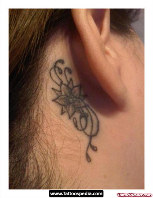 Grey Ink Flower Behind Ear Tattoo