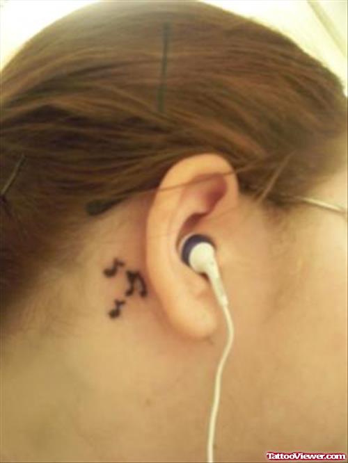 Black Ink Music Notes Tattoo Behind Ear