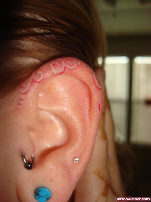 Red And White Ink Ear Tattoo