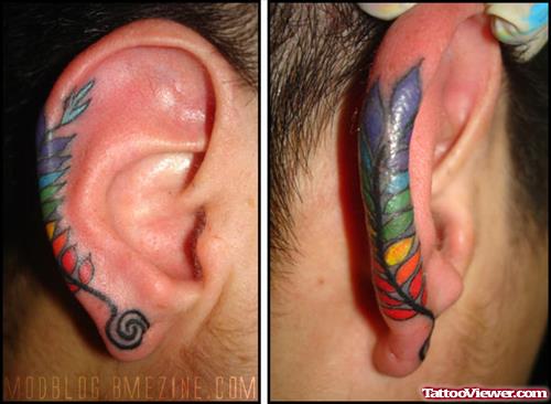 Colored Feather Tattoo On On Right Ear