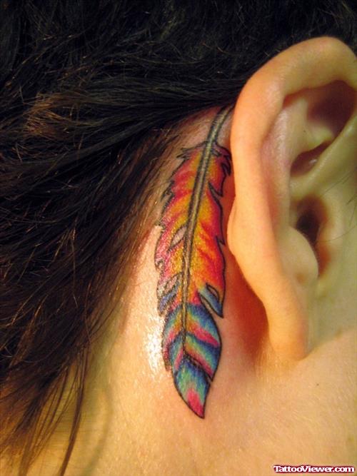 Colored Feather Behind The Ear Tattoo