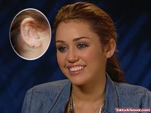 Smiling Miley Cyrus With Ear Tattoo