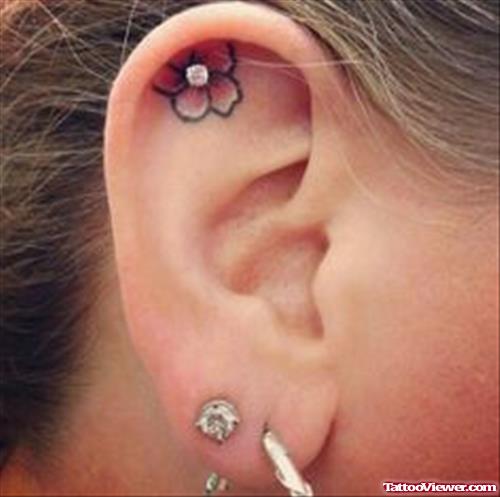 Flower With Piercing Ear Tattoo