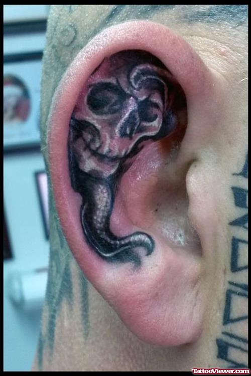 Grey Ink Skull Right Ear Tattoo