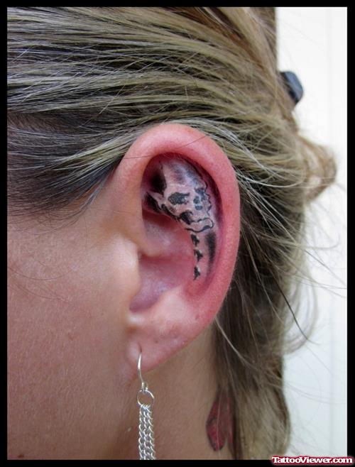 Grey Ink Skull Ear Tattoo