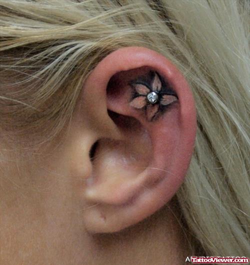 Ear Flower Tattoo With Piercing