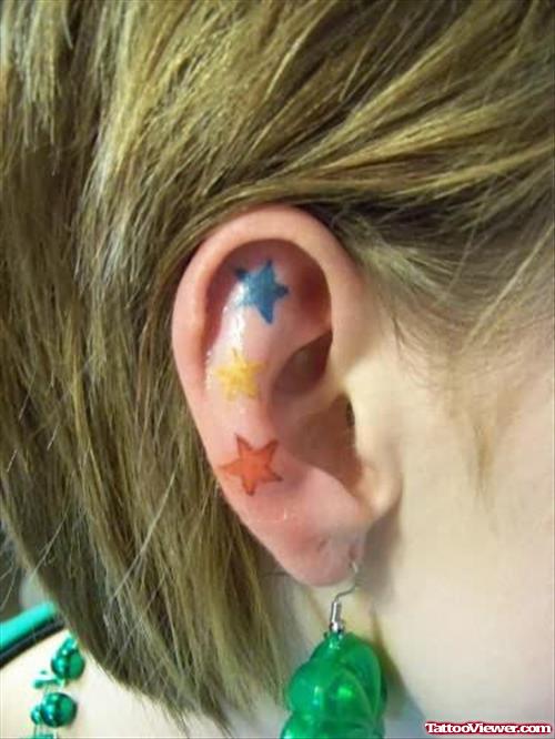 Three Colorful Star Tattoo On Ear