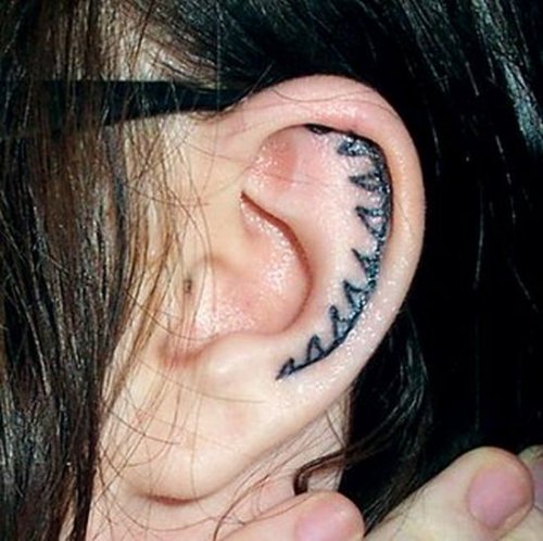 Awesome Black Ink Tattoo In Ear