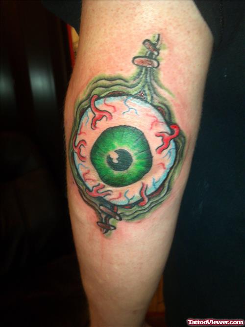 Ripped Skin Green Eyeball Elbow Tattoo