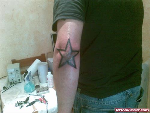 Amazing Black Star Elbow Tattoo