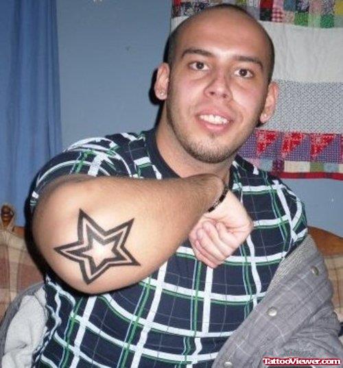 Guy With Black Star Elbow Tattoo