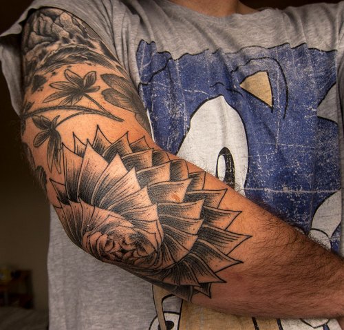 Grey And White Flower Tattoo On Right Elbow