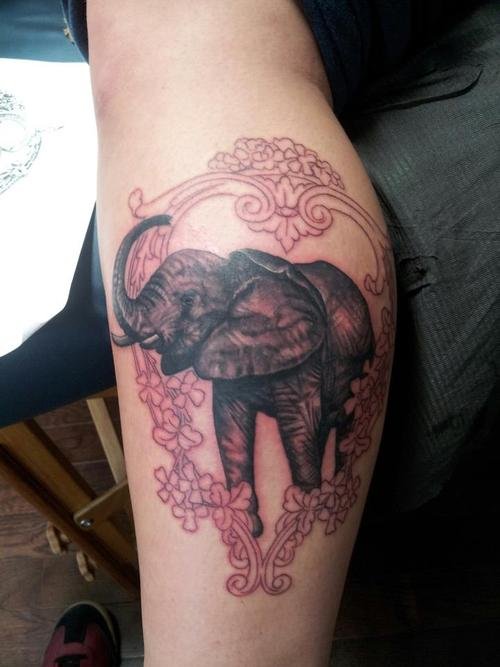 Flowers Frame And Elephant Tattoo On Leg