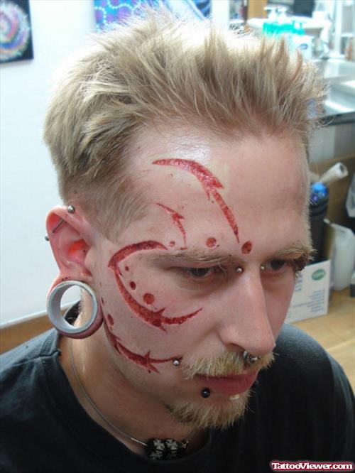 Extreme Scarification Tattoo On Face