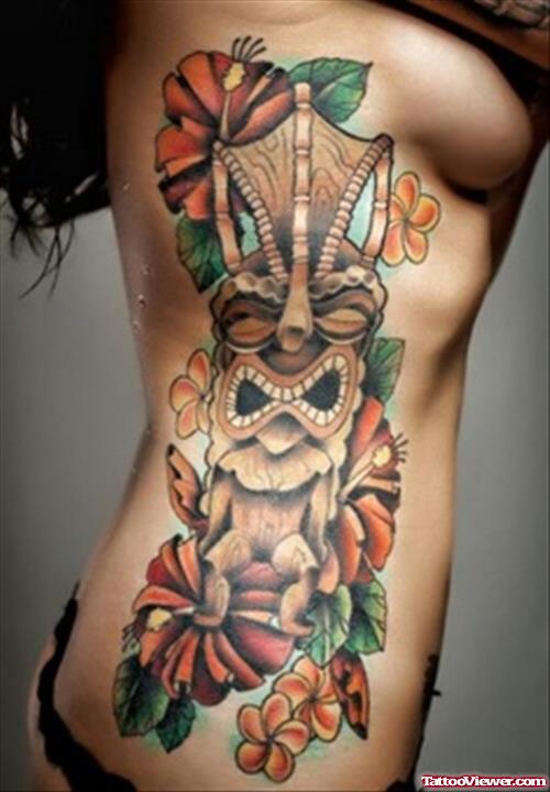 Extreme Flowers And Tiki Tattoo On Side Rib