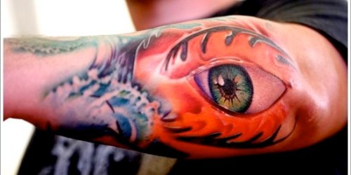 Colored Eye Tattoo On Left Arm