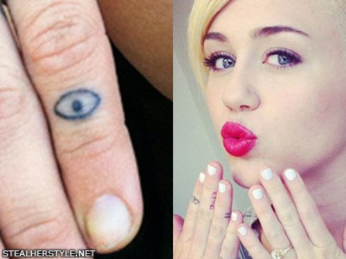 Miley Cyrus With Eye Tattoo On Finger