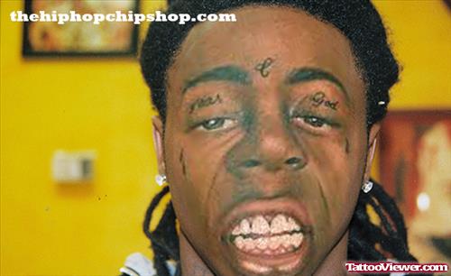 Lil Wayne Fear God And Tear Drops Face Tattoo
