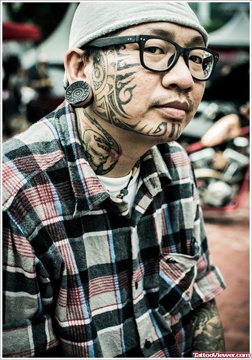 Traditional Black Ink Tribal Face Tattoo