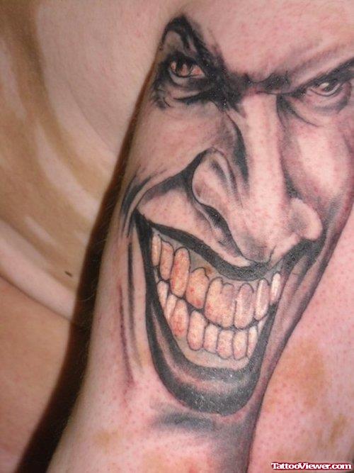 Grey Ink Clown Face Tattoo