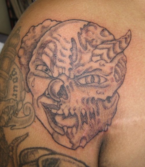 Grey Ink Zombie Demon Face Tattoo On Shoulder