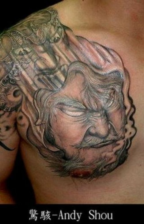 Grey Ink Chinese Face Tattoo On Chest