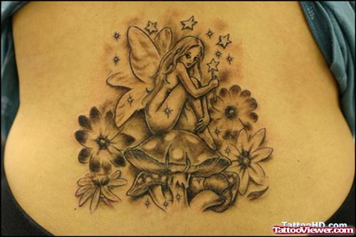 Grey Ink Flowers And Fairy Tattoo On Lowerback