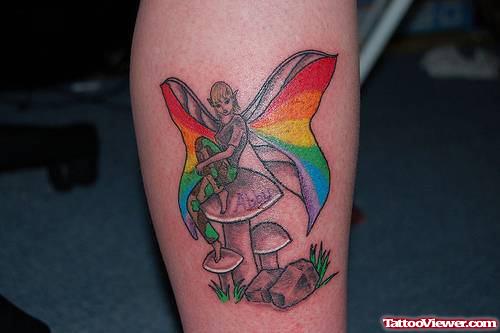 Awesome Colored Fairy Sitting On Mushroom Tattoo