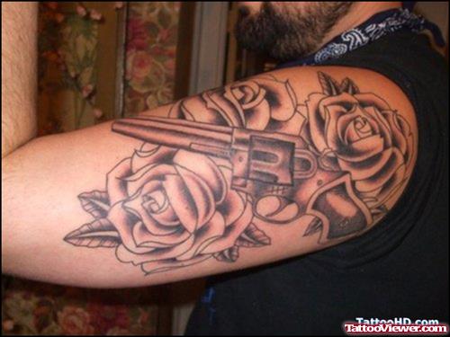 Grey Rose Flowers And Gun Faith Tattoo On Half Sleeve