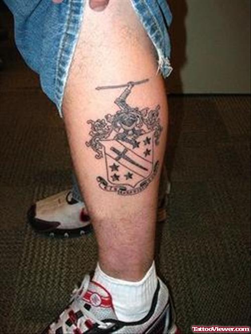 Grey Ink English Family Crest Tattoo On Left Leg