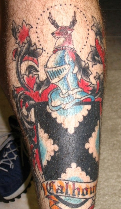 Awful Colored Family Crest Tattoo On Leg
