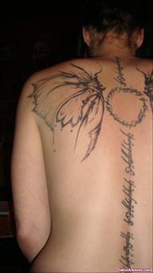 Grey Ink Lettering And Wings Fantasy Tattoo On Back