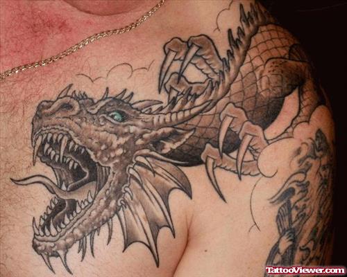 Grey Ink Fantasy Tattoo On Collarbone