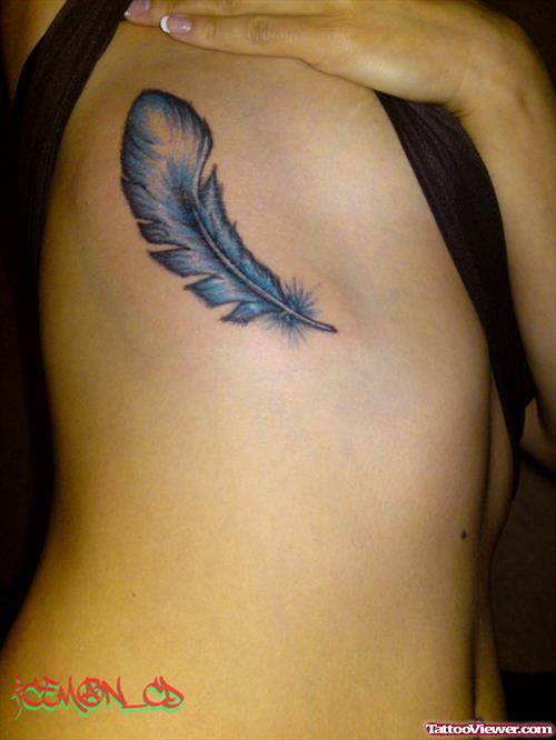 Blue Ink Feather Tattoo On Rib Side