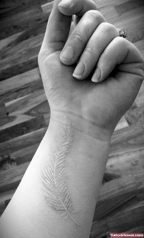 White Ink Feather Tattoo On Wrist
